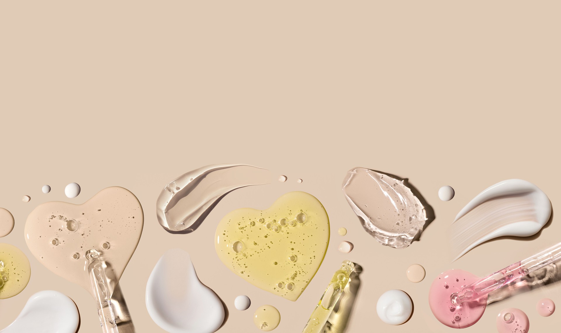 samples of cosmetic care products smear of cream texture on a beige background